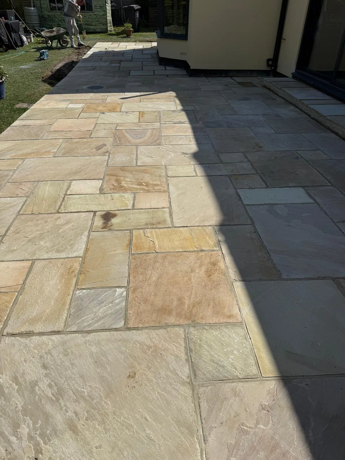 Riven buff Indian sandstone paving laid by Prestige Landscapes in Downe Village