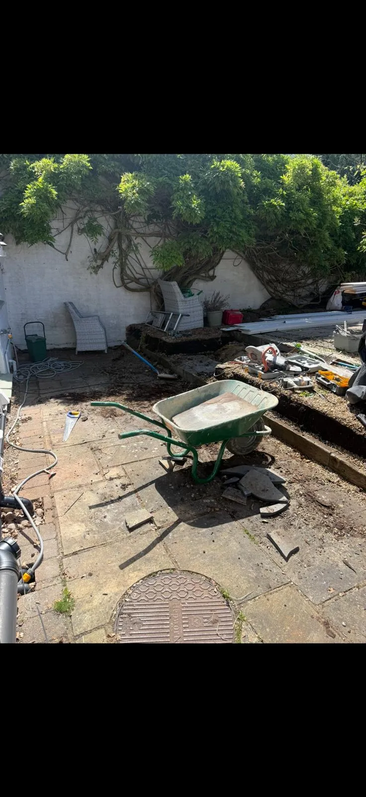 Groundworks in progress before a new grey porcelain patio was laid in Farnborough Village