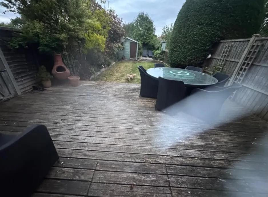 Weathered timber decking before removal in a Beckenham garden