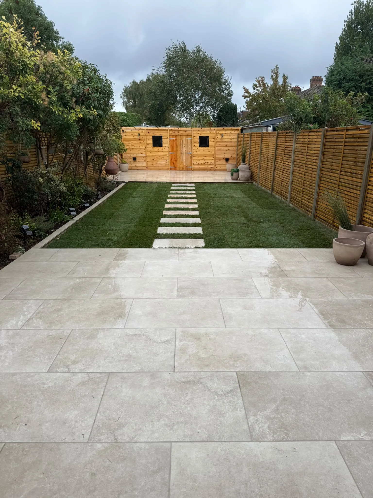 Finished porcelain patio and garden room in a Beckenham garden by Prestige Landscapes